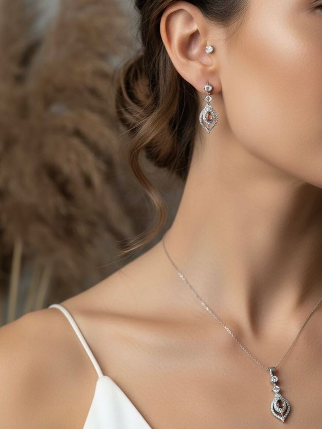 Close-up of a woman wearing silver earrings and a necklace with a blurred background